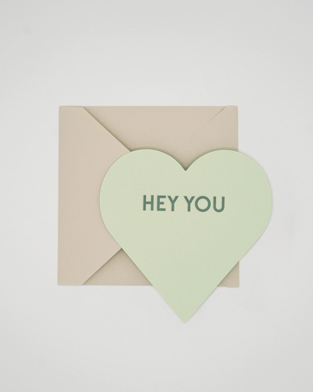 Letterpress green Valentine card in the shape of a heart with Hey You foiled